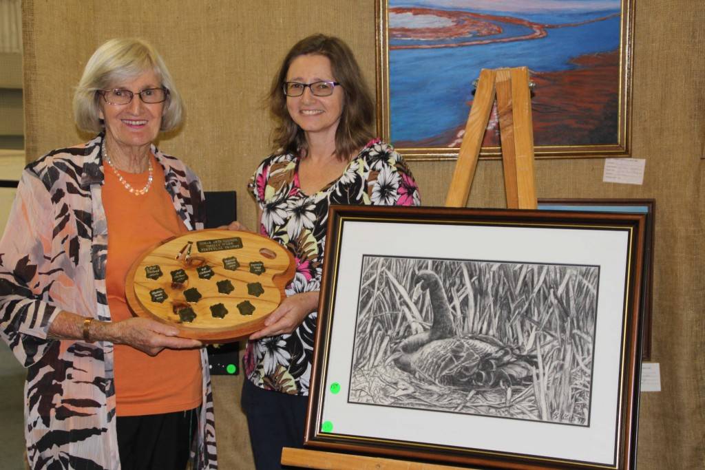 Cobar Arts Council president Issy Pretty presented Karen Watts with the Thelly Wade Perpetual Trophy for winning the visual arts category, last Wednesday night at the official opening of the Festival of the Miners Ghost Art & Photography Exhibition.