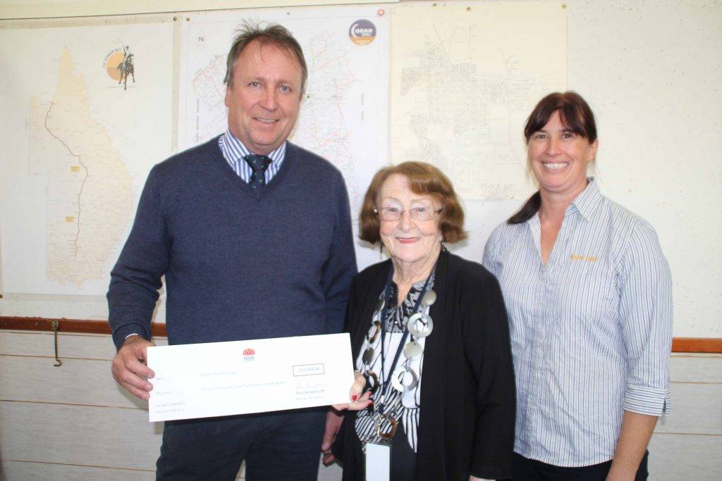 State Member for Barwon Kevin Humphries presented a cheque for $11,910 to Cobar Shire Council Mayor Lilliane Brady and Cobar Business Association secretary Angela Shepherd last Tuesday at the council chambers. 
