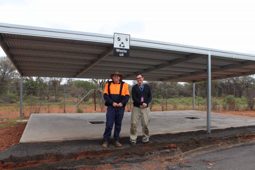 Cobar Shire Council staff Graham  Harbison and Stephen Poulter at the new waste oil and battery deposit area at the Cobar Waste Depot.